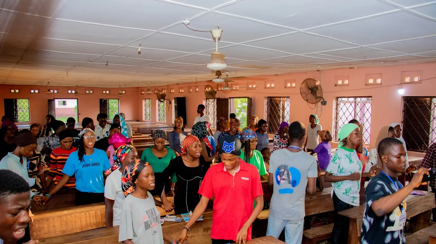 Church family worshipping together at Adoration New Life Ministry, Aiyepe