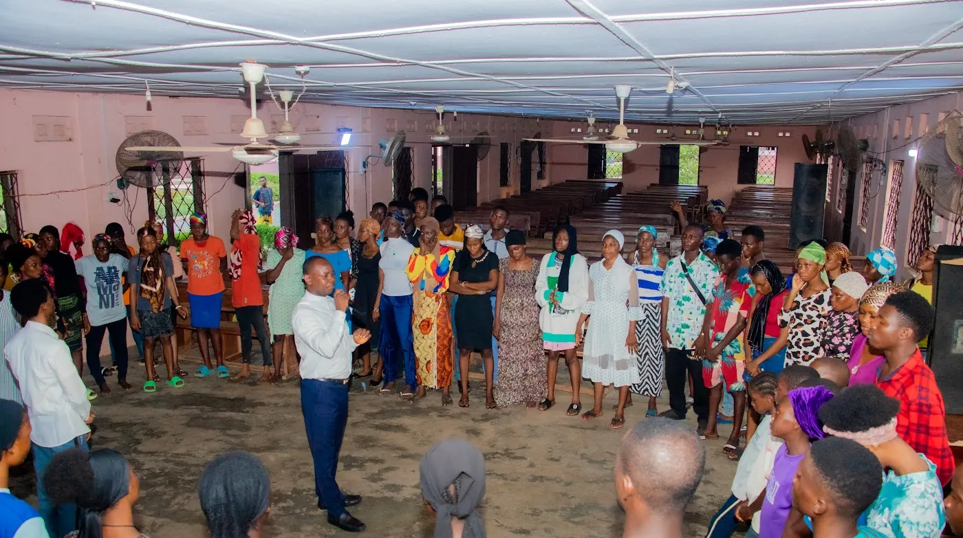 The church family at Adoration New Life Ministry praying together in Aiyepe, Ijebu