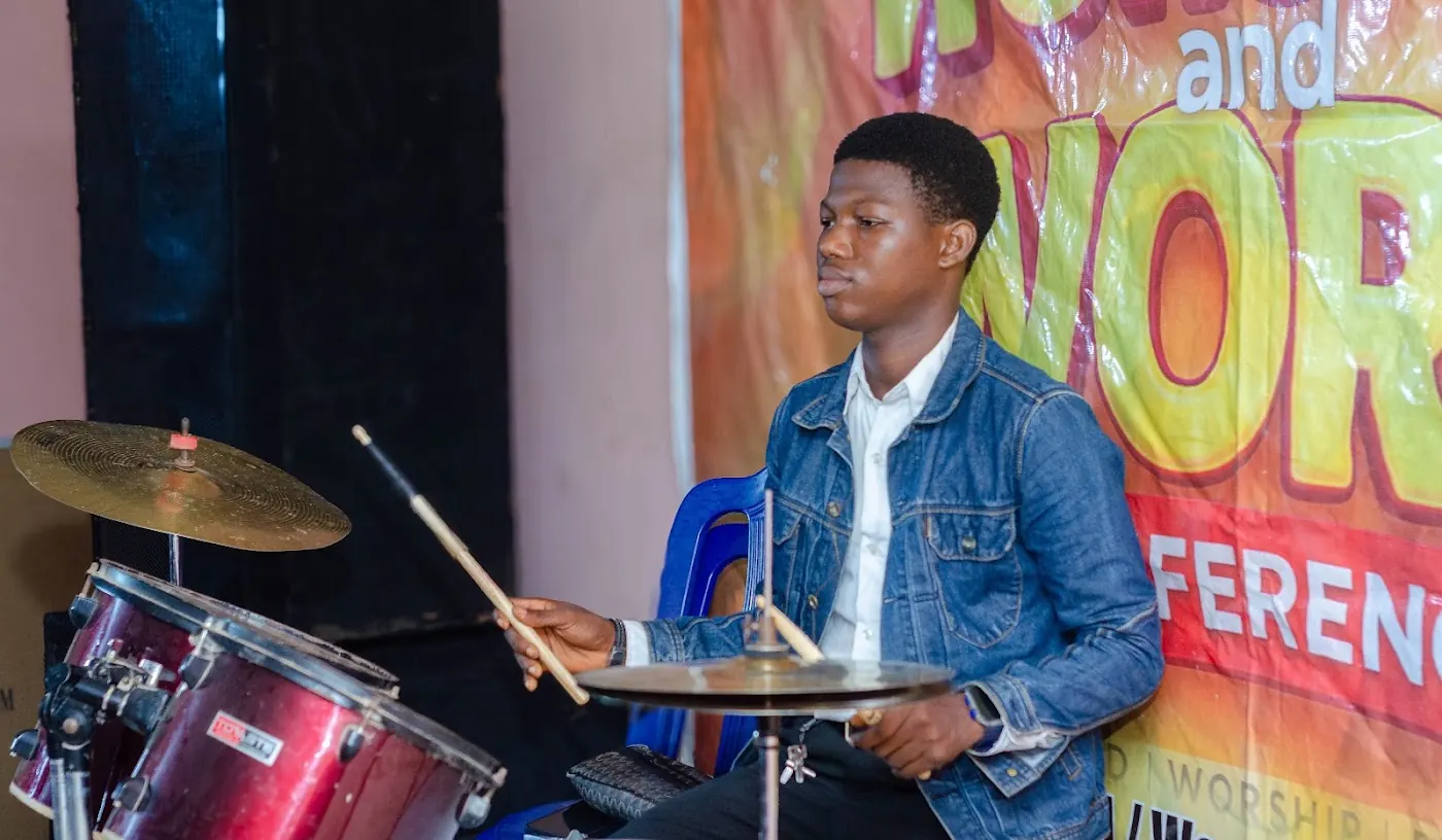 Musician playing drums during worship at the Worship and Word Conference, Aiyepe, Ijebu