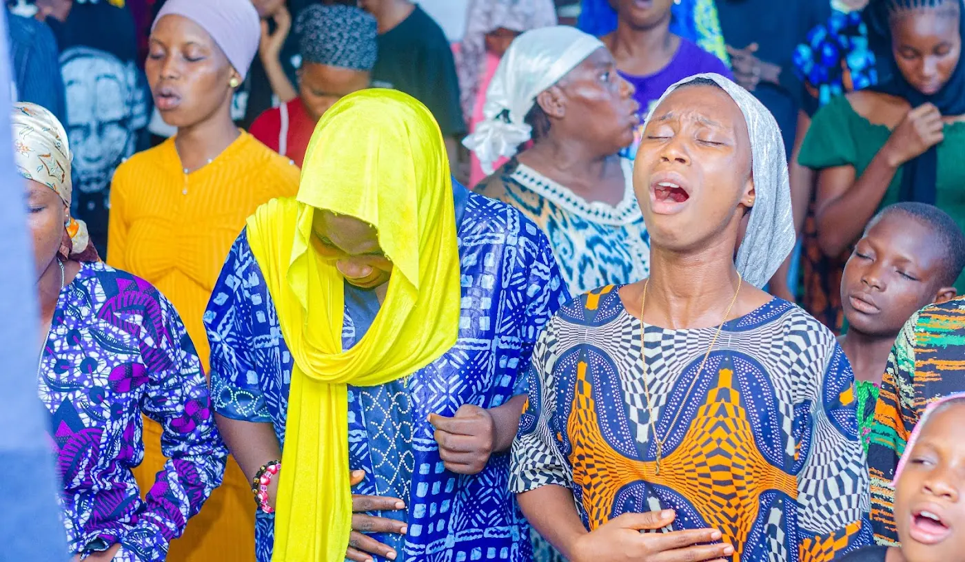 Young believers praying at a Worship and Word Conference in Aiyepe, Ijebu